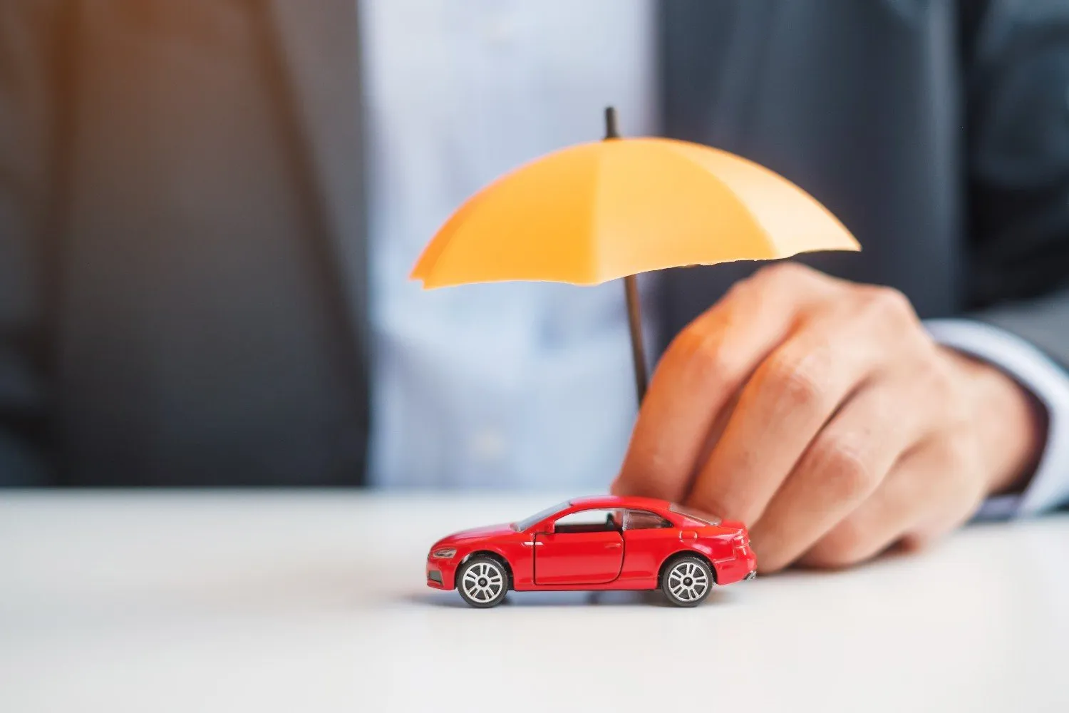 Umbrella held over a car to show claim day support